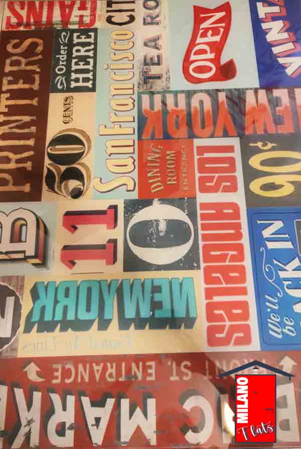 944tavolo-pranzo-vetro-disegno-targhe-vintage-monolocale-airbnb-via-illirico-milano